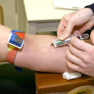 A patient having blood collected for a cholesterol test